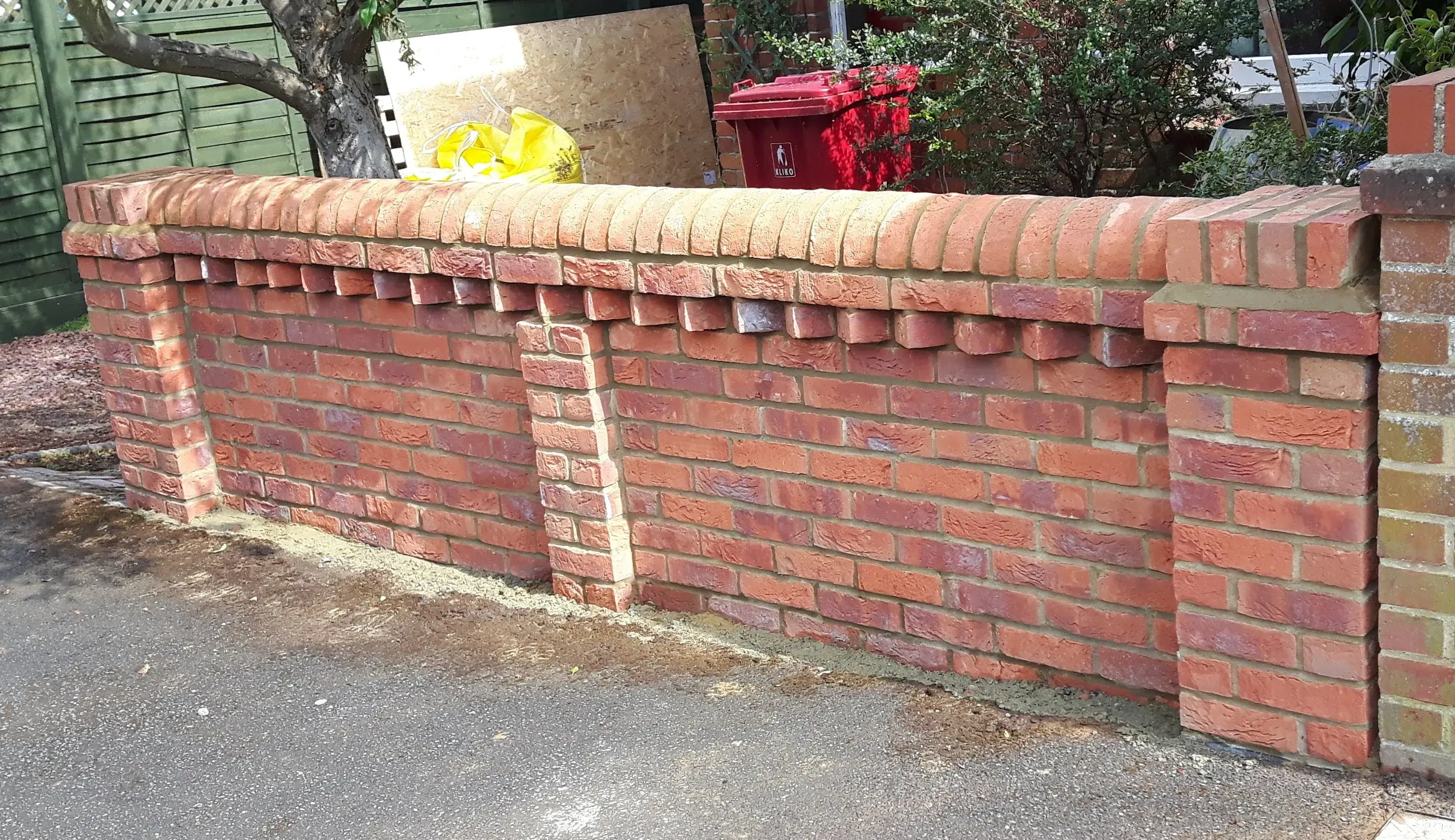 A brick wall with a fire hydrant in the background.